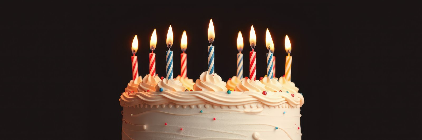 Colorful birthday cake with lit candles celebrating a special moment
